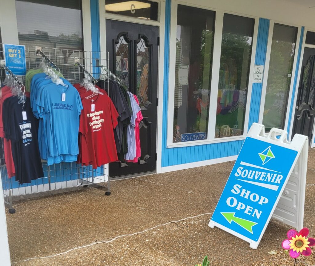 Souvenir shop in Fairfield Bay with T-shirts hanging outside.