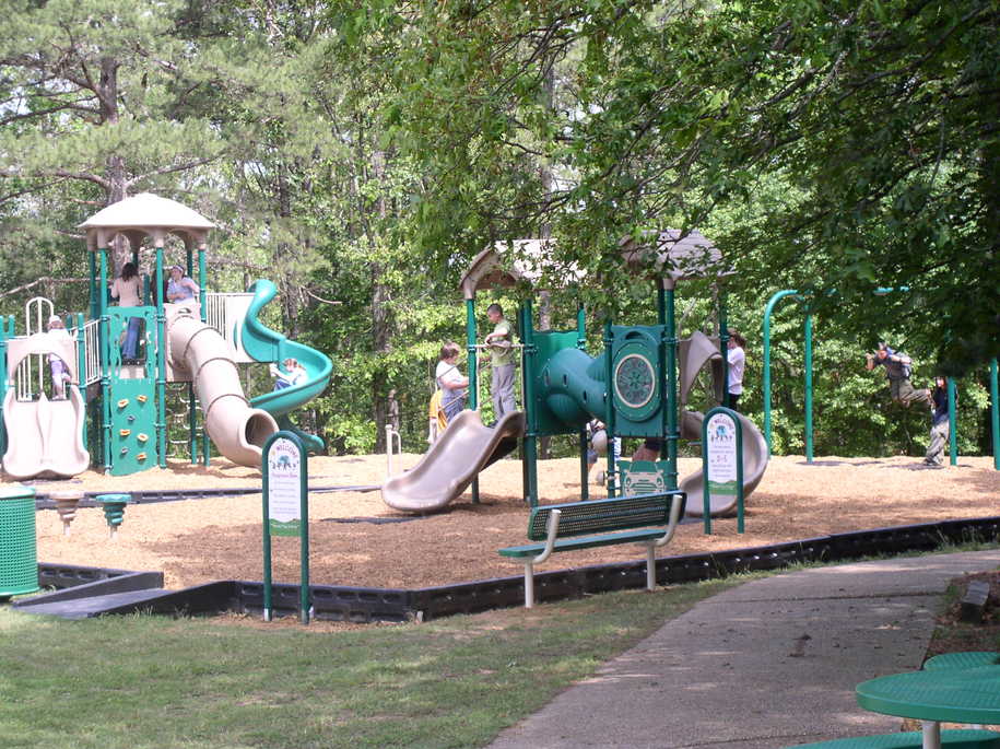A playground at Woodland Mead Park with children playing.